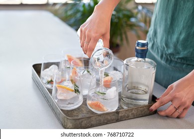 Woman Pouring Tonic Soda Water Into Glasses, Preparing Alcoholic Beverages At A Party