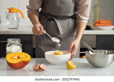 A Woman Pours Flour Into A Bowl For Making Pumpkin Pie