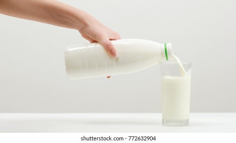 Woman Pours Milk. Dairy Products. Calcium ,vitamin D And Amino Acids Concept. Fitness Lifestyle.