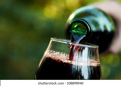 Woman pours wine into a glass background - Powered by Shutterstock