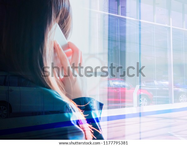 woman power\
and industry 4.0 concept from beauty hand of asian business woman\
in black suit use her smart phone take for  success job car seller\
with soft focus showroom \
background