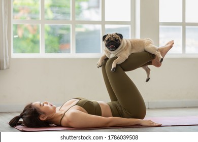 woman practice yoga with dog pug breed enjoy and relax with yoga at home,Recreation with Dog Concept