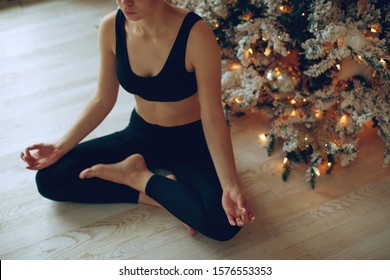 A Woman Practices Yoga At Christmas. 