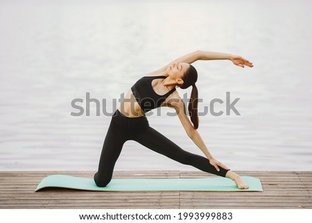 Similar – Active slim young woman doing yoga by the lake