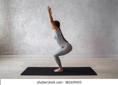 Woman Practicing Advanced Yoga. A Series Of Yoga Poses. Chair Pose. Utkatasana