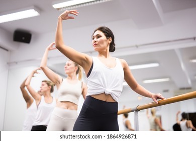 Woman practicing ballet elements in dance class