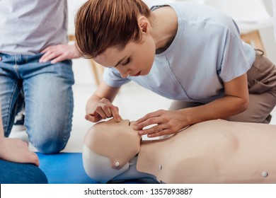 Woman Practicing Cpr Technique On Dummy During First Aid Training