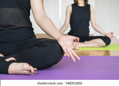 Woman Practicing Difficult Yoga Pose In A Yoga Class