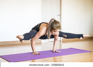 Woman Practicing Difficult Yoga Pose At Home