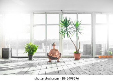 Woman Practicing Garland Pose During Her Yoga Class