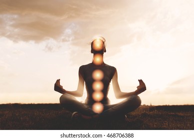 Woman Practicing Meditation In Sunset, With Chakras Marked