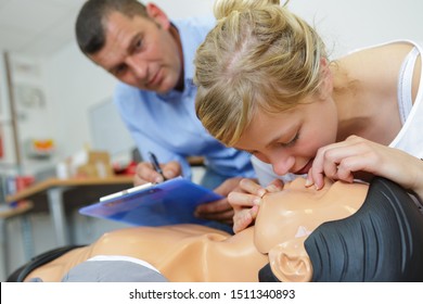 Woman Practicing Mouth To Mouth Resuscitation