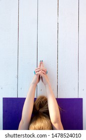 Woman Practicing Outdoors On Violet Yoga Mat. Overhead Close Up Of Female Hands In Mudra On White Wooden Background