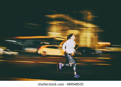 Woman Practicing Running In The City At Night