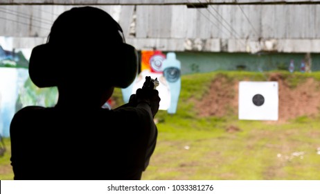 Woman Is Practicing Shooting At A Shooting Range.