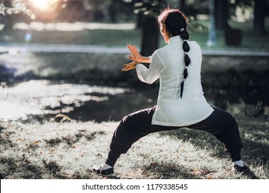 Woman practicing Tai Chi Quan in the park