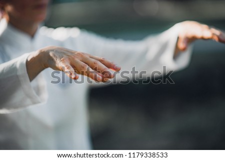 Woman practicing Tai Chi Quan in the park
