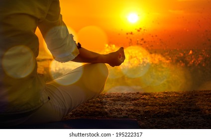 Woman Practicing Yoga by the Sea at Sunset. Beautiful Toned Photo with Golden Bokeh. Healthy Lifestyle Concept.