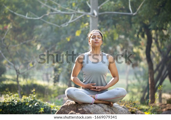 Woman Practicing Yoga Lotus Position Park Stock Photo 1669079341 ...