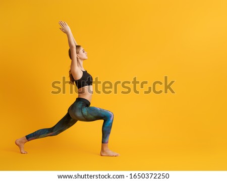 Woman is practicing yoga and meditation on color background.                                