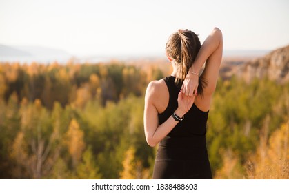 woman practicing yoga  on the mountain in autumn.  solo outdoor activities. Social Distancing  - Shutterstock ID 1838488603