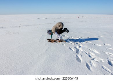 Woman Practicing Yoga On Snow