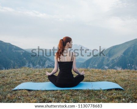 woman practicing yoga outdoors in the mountains
