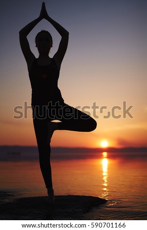 Similar – Young woman doing yoga in nature