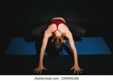 Woman Practicing Yoga In Studio, Yogi Squat Forward Fold