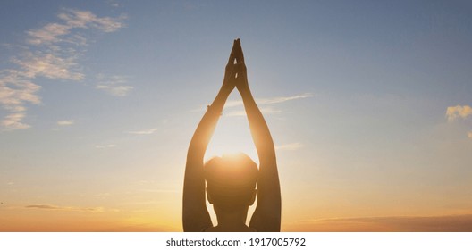 Woman practicing yoga, sunset. Healing concept. Silhouette young woman practicing yoga on the sunset.Tranquility and concentration. - Powered by Shutterstock