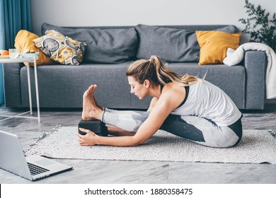 Woman Practicing Yoga Use Block At Home.