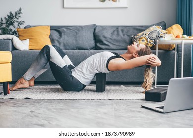 Woman Practicing Yoga Use Blocks At Home.