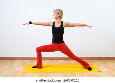 Woman practicing yoga. Yoga-Virabhadrasana /Warrior pose 