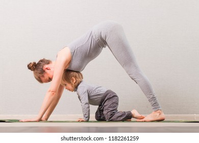 woman practicing yoga with your child