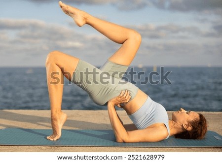 Similar – Image, Stock Photo Flexible woman performing headstand pose in yoga studio