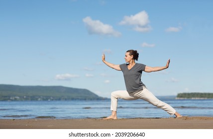 Woman praticing tai chi chuan on the beach. Chinese management skill Qi's energy. solo outdoor activities. Social Distancing 
