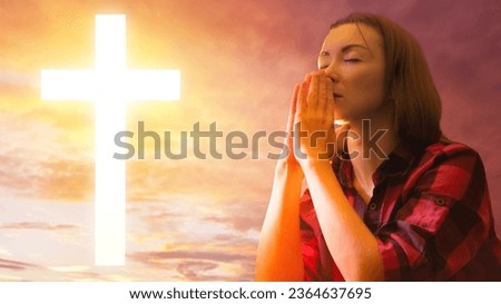 Woman pray to god. Believing girl near crucifix. Lady makes prayer gesture. Catholic woman. Praying female near sunset. Luminous christian cross. Believing girl pray. Faith, religion