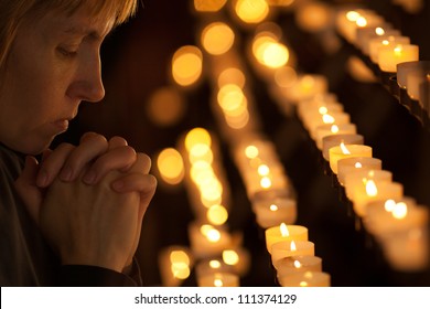 Woman Praying In Catholic Church