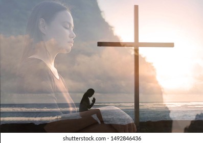 A Woman Praying With A Cross Outside.