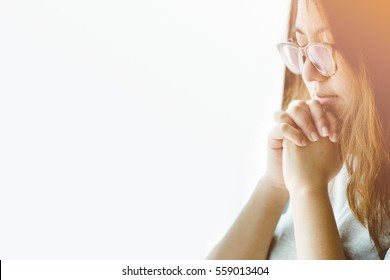 Woman praying near the window in the morning.Online worship.Teenager woman hand praying,Hands folded in prayer.Give thank,Happy Thanksgiving day concept for faith, spirituality, Holidays and religion.