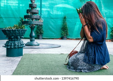 Woman Praying On Her Knees
