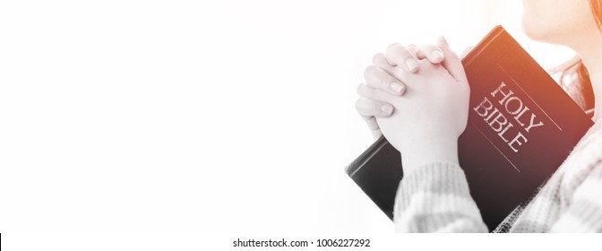 Woman Praying On Holy Bible In The Morning.teenager Woman Hand With Bible Praying,Hands Folded In Prayer On A Holy Bible In Church Concept For Faith, Spirituality,worship And Religion.