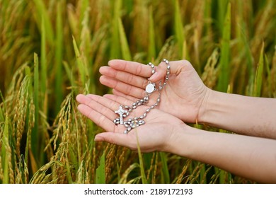 Woman Praying With Rosary Outside. Close-up.  Vietnam. 