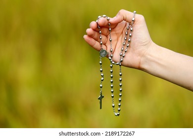 Woman Praying With Rosary Outside. Close-up.  Vietnam. 