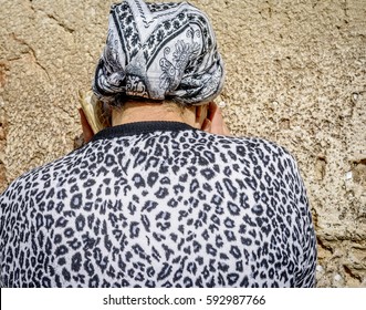Woman praying at the Western Wall.