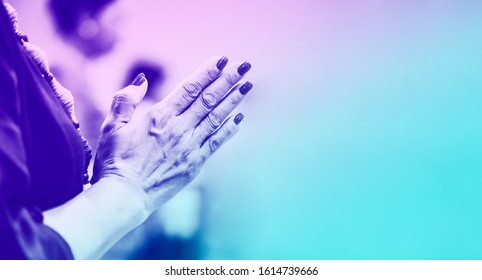 Woman praying and worship to GOD in Church.Senior woman pray to GOD.Hand praying and palm up,Concept Praise and worship with faith, spirituality and Surrender.