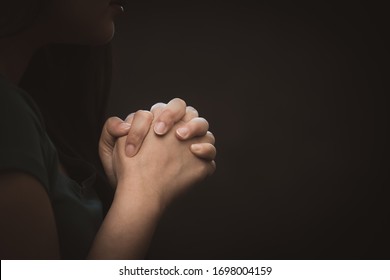 woman praying and worship to GOD Using hands to pray in religious beliefs and worship christian in the church or in general locations in vintage color tone or copy space.