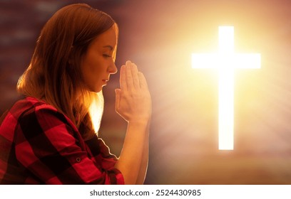 Woman prays to god. Girl makes prayer gesture. Christian crucifix near girl. Catholic believer praying at sunset. Portrait of praying woman. Lady praying and asking gentlemen for help - Powered by Shutterstock