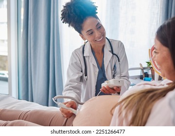 Woman, pregnancy and doctor, ultrasound at clinic with happiness, excited and family planning for future. Black woman medic, pregnant woman and consulting with medical tech on stomach for sonogram