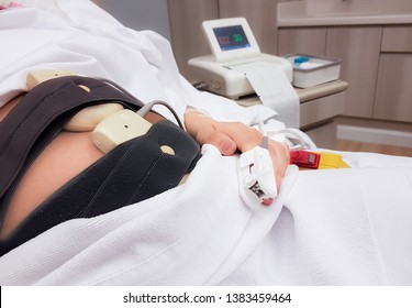 Woman Pregnant Checking Fetal Heart Beat By Fetal Monitoring And Being Measured Oxygen From The Fingertip,Expectant Mother With Midwife Adjusting Sensors Of Cardiotocograph(CTG) Or Non Stress Test(NST